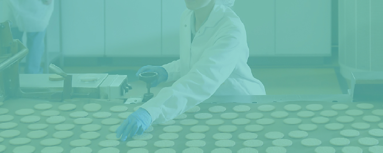 Laborangestellte in Kittel und Laborhandschuhen arbeitet mit einer großen Menge Laborschalen auf einem Tisch, grünes Overlay